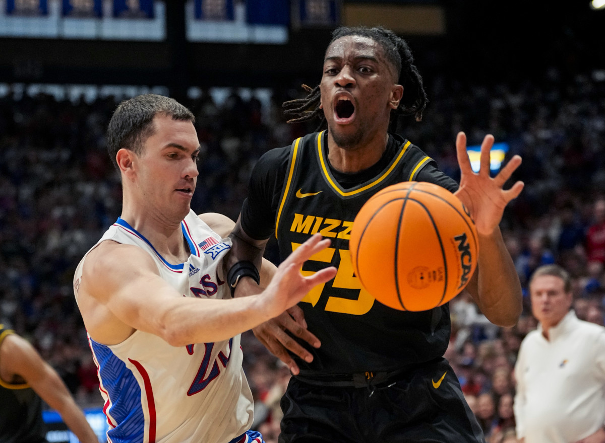 Dec 9, 2023; Lawrence, Kansas, USA; Kansas Jayhawks guard Nicolas Timberlake (25) knocks the ball away from Missouri Tigers guard Sean East II (55) during the first half at Allen Fieldhouse.